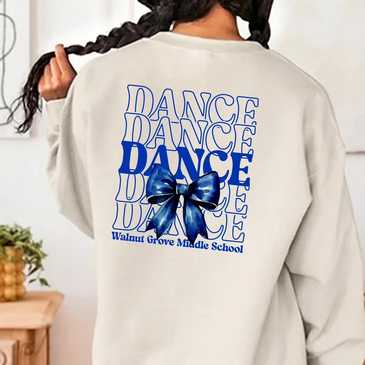 A person with long hair and a sweater